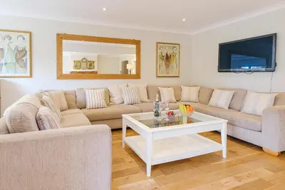 a living room with two couches and a table at Turret House, Thorpeness - Close to the beach, Thorpeness Lake , Thorpeness Hotel, Golf and Country Club - Aldeburgh Coastal Cottages in Thorpeness