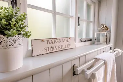 a window ledge with a sign that reads backyard sunshine at Margo's Cottage, Orford in Orford