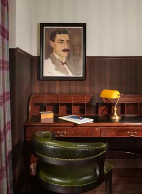 a desk with a picture of a man on it at Graduate by Hilton Cambridge in Cambridge