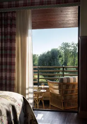 a bedroom with a view of a balcony with a window at Graduate by Hilton Cambridge in Cambridge