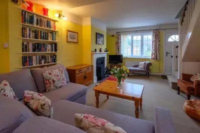 a living room with two couches and a table at 4 Old Homes, Thorpeness - Only a stones throw from the beach - Aldeburgh Coastal Cottages in Thorpeness