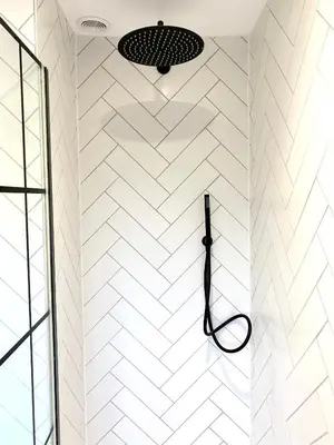 a bathroom with a shower with white subway tiles at Stylish Cambridge Pad in Bar Hill