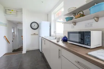 a kitchen with a counter top with a microwave at Beaver Cottage in Aldeburgh