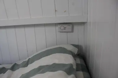 a bedroom with a bed and a clock on the wall at Waterbeach Boatel in Cambridge