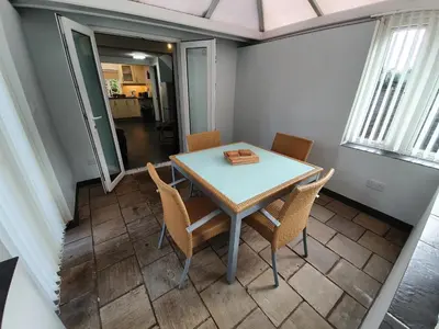 a dining room with a table and chairs at Low Farm Cottages in Woodbridge