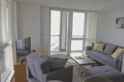 a living room with a couch and a tv at Toothbrush Apartments - Ipswich Waterfront South - Avalon Court in Ipswich