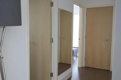 a room with a mirror and a hallway with doors at Toothbrush Apartments - Ipswich Waterfront South - Avalon Court in Ipswich