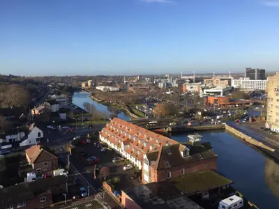 an aerial view of a city with a river and buildings at Toothbrush Apartments - Ipswich Waterfront South - Avalon Court in Ipswich