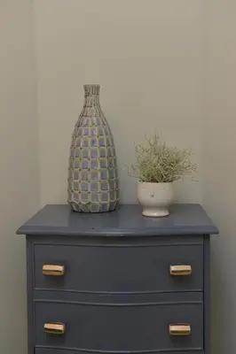 a blue dresser with a vase and a plant on it at 10A Ruston Chambers Free parking, Luxury 2 bedroom city center apartment in St Ives