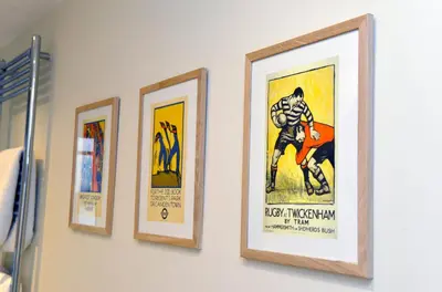 a group of four framed posters on a wall at 10A Ruston Chambers Free parking, Luxury 2 bedroom city center apartment in St Ives