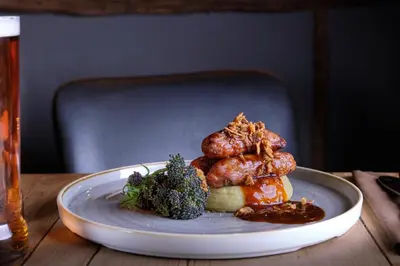 a plate of food on a wooden table at The Three Blackbirds in Stetchworth