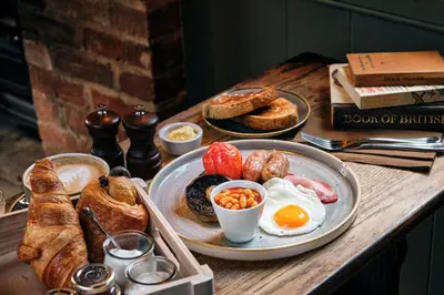 a table with a breakfast of eggs and bread at The Three Blackbirds in Stetchworth