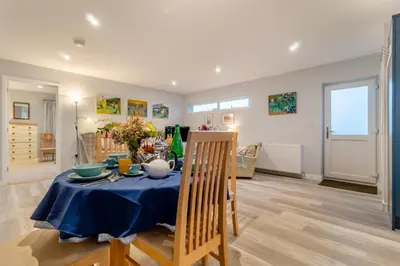 a dining room with a table with a blue table cloth at 2 Bed in Snape oc-sfvin in Snape