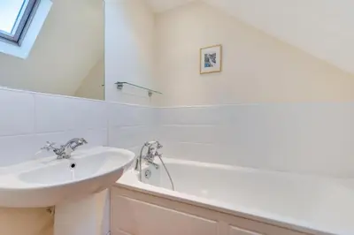 a white bathroom with a sink and a bath tub at 1 Bed in Aldeburgh oc-sld in Aldeburgh