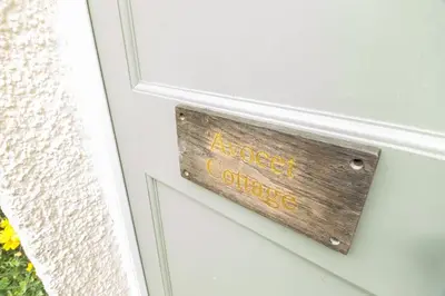a wooden sign on a door with the words guest services at 1 Bed in Sizewell oc-gdnf in Sizewell