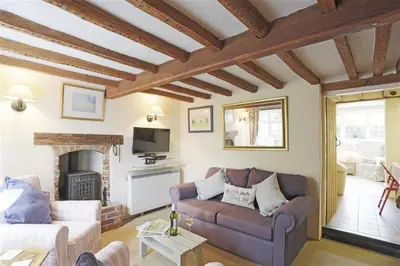 a living room with a couch and a fireplace at 1 Bed in Great Bealings oc-rosec in Bealings