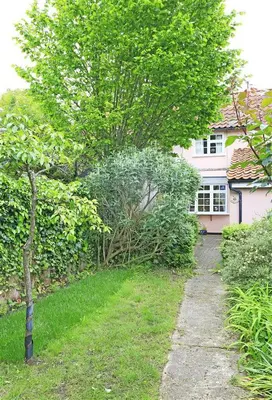 a tree in front of a house with a driveway at 1 Bed in Great Bealings oc-rosec in Bealings