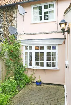 a pink house with a window and a street light at 1 Bed in Great Bealings oc-rosec in Bealings