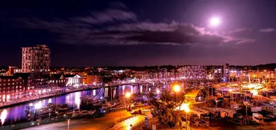 a city at night with a river and buildings at Toothbrush Apartments - Ipswich Waterfront - Quayside in Ipswich