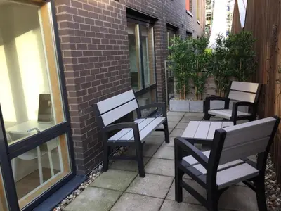 a row of benches sitting on a patio at Toothbrush Apartments - Ipswich Waterfront - Quayside in Ipswich