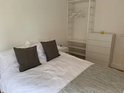 a white bed with two pillows on it in a bedroom at Toothbrush Apartments - Ipswich Waterfront - Quayside in Ipswich