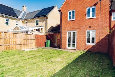 a backyard of a brick house with a fence at Comfortable Colchester Home in Colchester