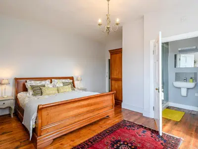 a bedroom with a bed and a bathroom at Colveston Manor in Cranwich