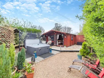 a backyard with a hot tub in a yard at Easthorpe Retreat in Copford