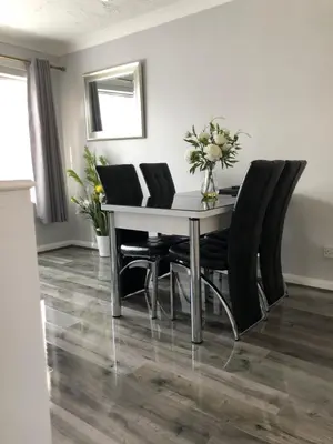 a dining room with a table and black chairs at Peaceful 3 Bed Home in Basildon