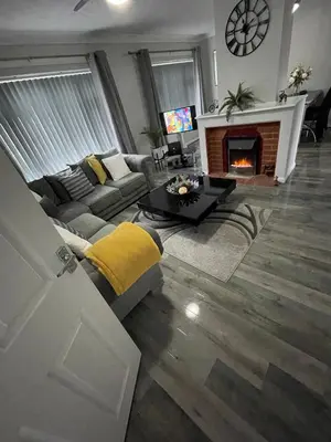 a living room with a couch and a fireplace at Peaceful 3 Bed Home in Basildon