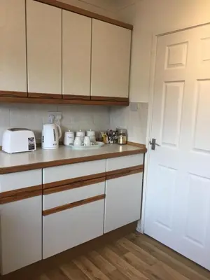 a kitchen with white cabinets and a white door at Peaceful 3 Bed Home in Basildon