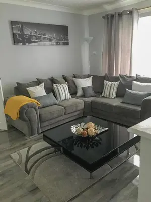 a living room with a couch and a coffee table at Peaceful 3 Bed Home in Basildon