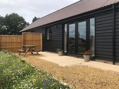 a house with a picnic table in front of it at Fox Lodge - Uk30605 in Pidley