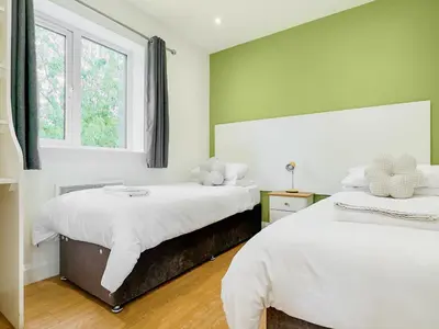 a bedroom with two beds and a window at Badger Lodge - Uk30603 in Pidley