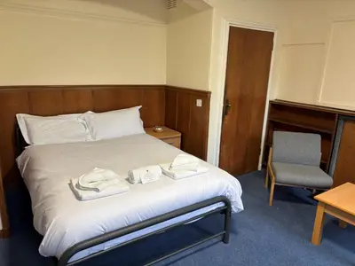 a bedroom with a bed with two towels on it at Christ's College Cambridge in Cambridge