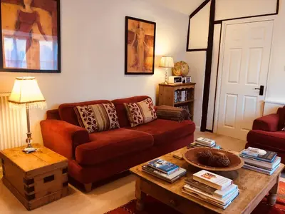 a living room with a couch and a coffee table at The Blue Cow in Fenstanton