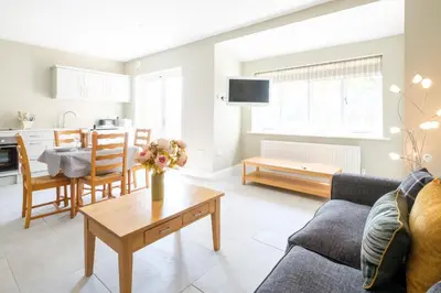 a living room with a couch and a table at The Dower Cottage in Sizewell