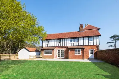 a large brick house with a large yard at The Dower Cottage in Sizewell