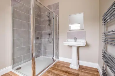 a bathroom with a shower and a sink at The Dower House in Sizewell