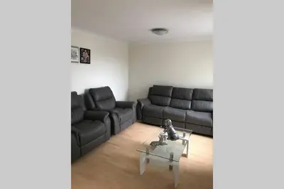 a living room with a couch and a table at A Home Away from Home in Ipswich