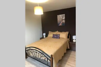 a bedroom with a bed and a black wall at A Home Away from Home in Ipswich