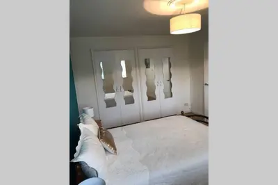 a room with a bunch of utensils hanging on the wall at A Home Away from Home in Ipswich