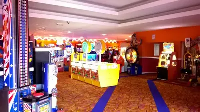 a room with many video games and a arcade at 2013 Willerby Sunset Static Caravan Holiday Home in Clacton-on-Sea