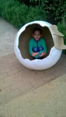 a young boy sitting inside of a tunnel at 2013 Willerby Sunset Static Caravan Holiday Home in Clacton-on-Sea