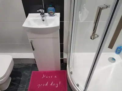 a bathroom with a shower and a sign that says have a good day at Orwell Suite in Ipswich