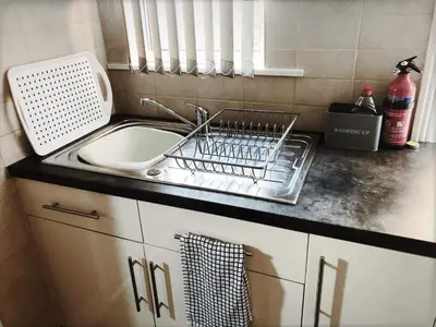 a kitchen sink with a dish drying rack next to it at Richmond Luxury flat Fabulous location in Southend-on-Sea