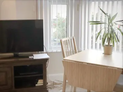 a living room with a table and a flat screen tv at Richmond Luxury flat Fabulous location in Southend-on-Sea