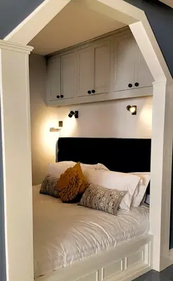 a bed with a built in headboard in a room at City Studios in Ely