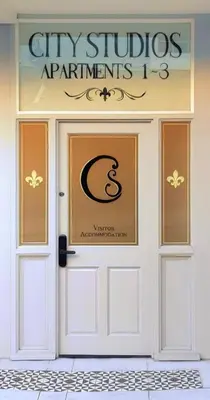 a white door with a sign on top of it at City Studios in Ely