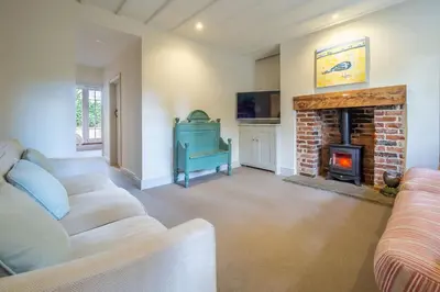 a living room with a couch and a fireplace at Alexander House 4 in Thorpeness